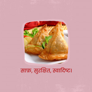 Close-up of golden-brown samosas with a side of chutney and lemon