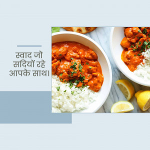 Close-up of Butter Chicken served with rice and lemon wedges