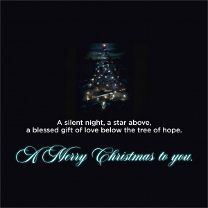 Christmas tree with lights and a festive message