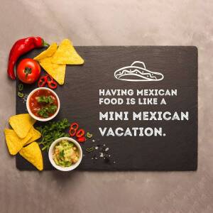 Overhead shot of Mexican food ingredients and a slate board with a quote.