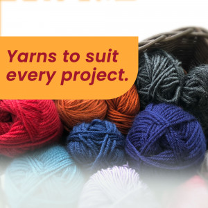 A close-up of various colorful yarn balls in shades of red, orange, blue, turquoise, and white.