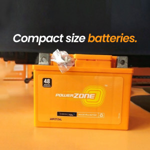 Close-up of an orange Power Zone 48V battery with plastic wrap on top.