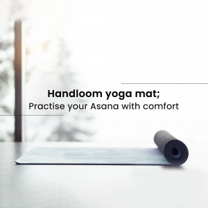Rolled handloom yoga mat on a light surface with a blurred background.