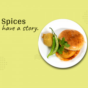 Close-up of a Vada Pav on a white plate with green chilies and garnish.