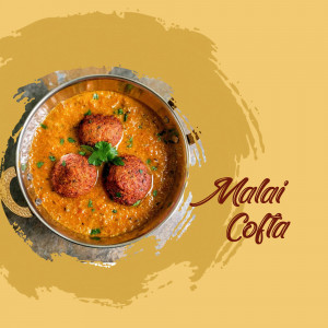 Close-up of Malai Kofta in a bowl with creamy sauce and garnish