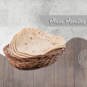 A stack of freshly made plain paratha in a woven basket