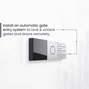 Close-up of a modern black and white automatic gate entry system control panel mounted on a white wall.