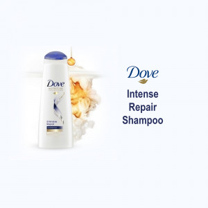 Dove Intense Repair Shampoo bottle with golden oil droplets and foam.