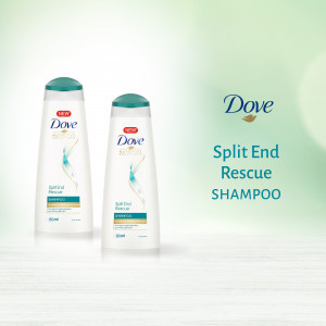 Two bottles of Dove Split End Rescue Shampoo on a light green background.