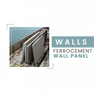 Ferrocement wall panels stacked on a construction site with a sea view.