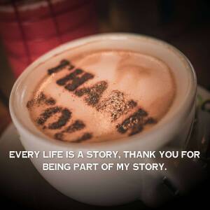 Close-up of a cappuccino with 'Thank You' written in cocoa powder.