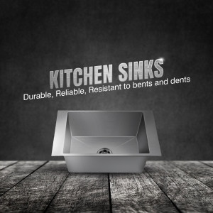 Stainless steel kitchen sink on a wooden surface