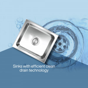 Close-up of a stainless steel kitchen sink with water swirling down the drain.