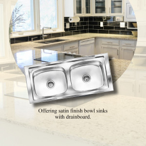 Close-up of a stainless steel double bowl kitchen sink with a satin finish and drainboard.
