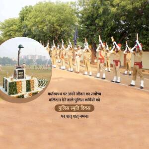 Indian police officers in formation with a memorial in the foreground