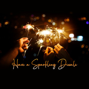 Hands holding sparkling Diwali firecrackers with text 'Have a Sparkling Diwali'