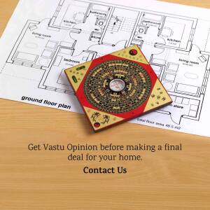A compass used in Vastu Shastra placed on top of a house floor plan.
