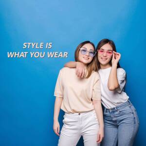 Two young women wearing sunglasses and casual clothing, posing against a blue background with text 'STYLE IS WHAT YOU WEAR'.
