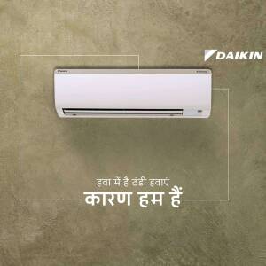 Daikin split air conditioner mounted on a textured wall with Hindi text.