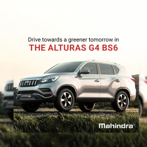 Silver Mahindra Alturas G4 BS6 SUV parked outdoors with a blurred background.