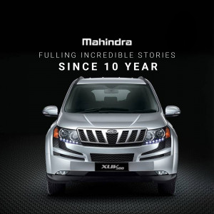 Front view of a silver Mahindra XUV500 with the tagline 'Fulling Incredible Stories Since 10 Year'