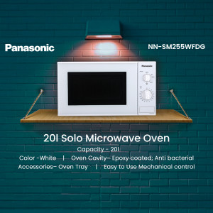 White Panasonic 20L Solo Microwave Oven on a wooden shelf against a teal brick wall