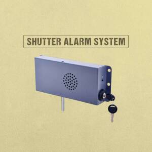 Close-up of a gray shutter alarm system with a key lock and key.