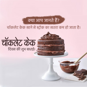 A delicious chocolate cake on a white stand with chocolate sauce and pieces.