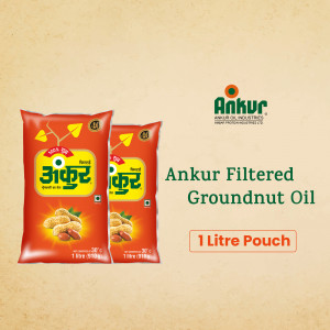 Two pouches of Ankur Filtered Groundnut Oil against a textured background.