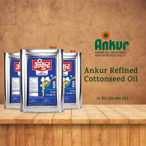 Three cans of Ankur Refined Cottonseed Oil on a wooden surface