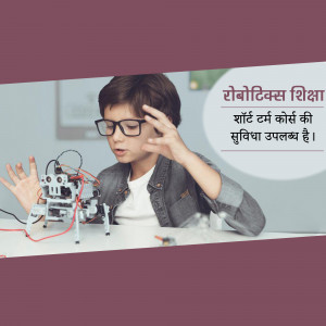 A young boy with glasses working on a robotics project.