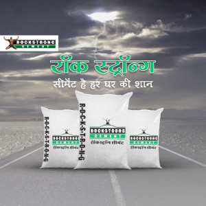 Three bags of Rockstrong Cement displayed on a road with a stormy sky background.