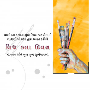 A hand holding paintbrushes with colorful paint, celebrating World Art Day.