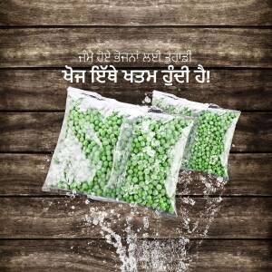 Three packages of frozen peas with condensation on a wooden surface.