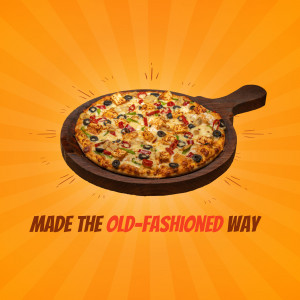 A close-up of a freshly baked pizza with colorful toppings served on a wooden paddle against a vibrant orange background.