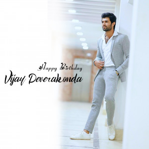 Vijay Deverakonda in a grey suit with birthday wishes