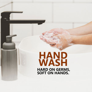 Close-up of hands washing with soap under a faucet
