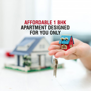 Hand holding a miniature house with keys, representing affordable housing.