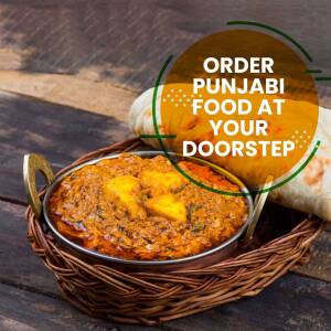 Close-up of a delicious Punjabi dish, likely Butter Chicken, with naan bread and a promotional banner.