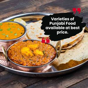 A close-up of a traditional Punjabi food platter with various dishes.