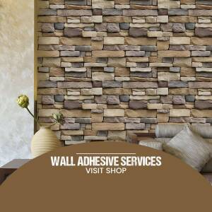 Close-up of a brick wall with an advertisement for wall adhesive services.