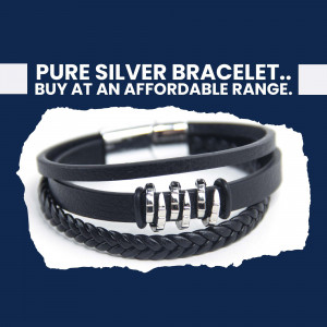 Close-up of a black leather and silver bracelet with a magnetic clasp.