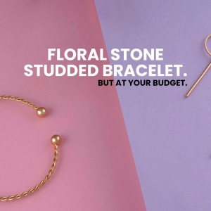 Close-up of a gold bracelet with floral stone studs on a pink and lavender background.