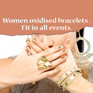 Close-up of a woman's hands showcasing gold and oxidized silver bracelets and rings.