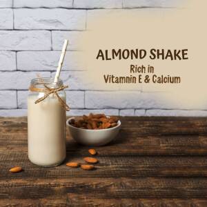 Glass of almond shake with almonds and twine
