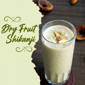 A glass of Dry Fruit Shikhanji with almonds and dried fruits.