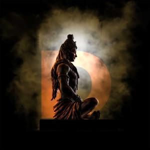 Silhouette of Lord Shiva meditating with a glowing orange circle in the background