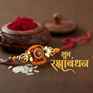 Close-up of a Rakhi bracelet with traditional decorations and sweets