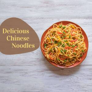 A top-down view of a plate of vibrant Chinese noodles with vegetables.