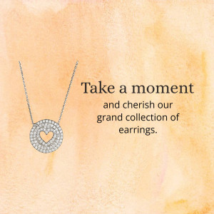 Close-up of a silver necklace with a diamond heart pendant on a peach background.
